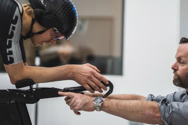 A competitive cyclist receiving advice on position &amp; technique